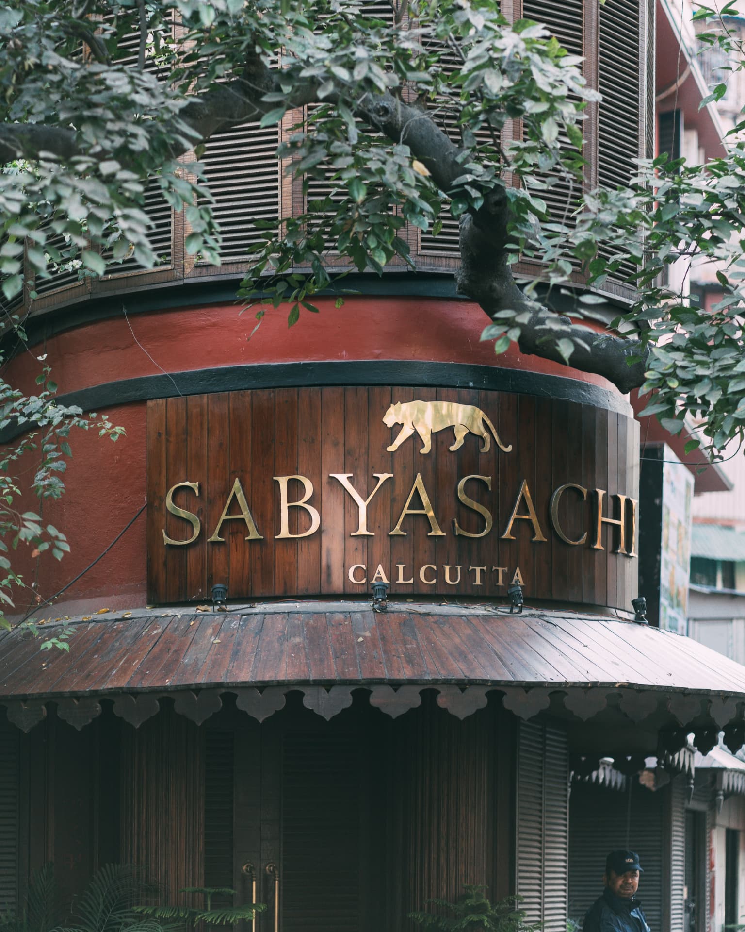 The Sabyasachi Calcutta storefront beneath a leafy canopy